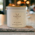 Whitetail candle from Kaevia in white glass jar with wood lid, situated on a marble decorative piece