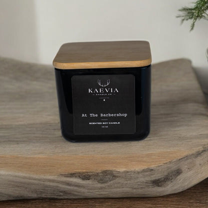 Kaevia Red Stag Trophy candle in a minimalist black jar with a natural lid on a tray