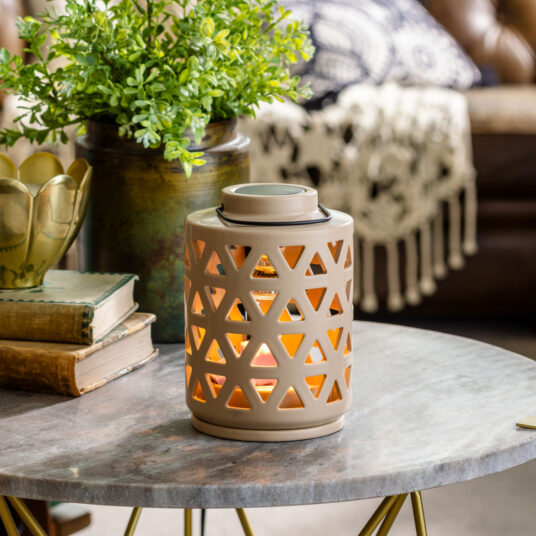 Circular trellis warmer on marble table